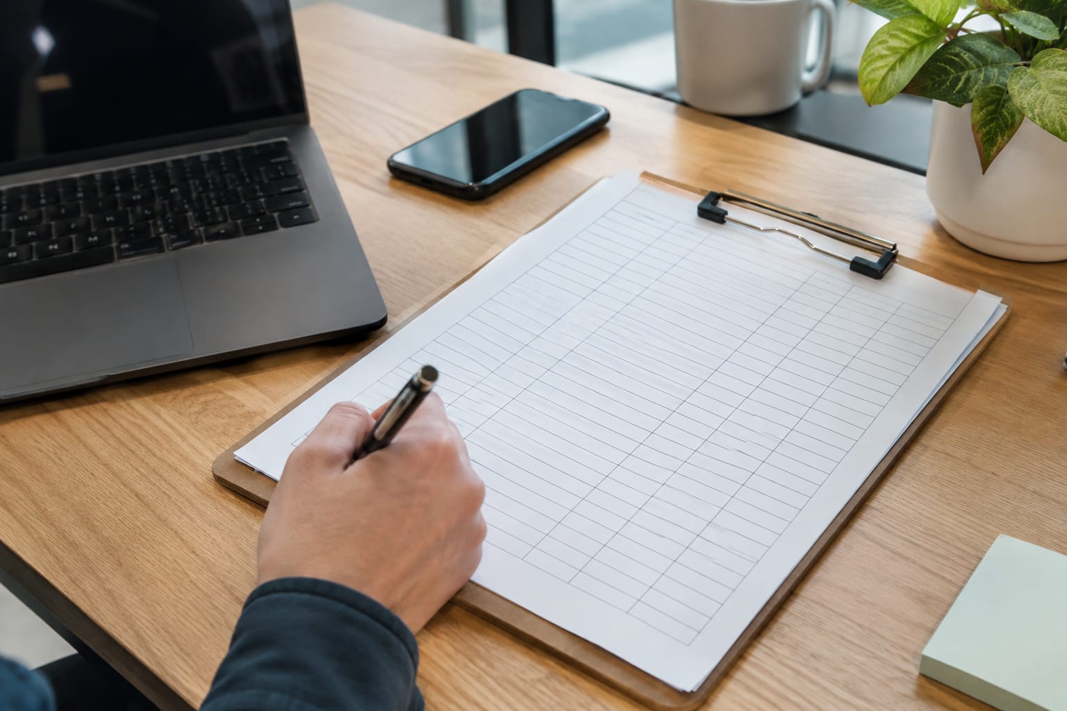 Clipboard with a printed tracking sheet with handwritten columns for question, engine, date and brands named