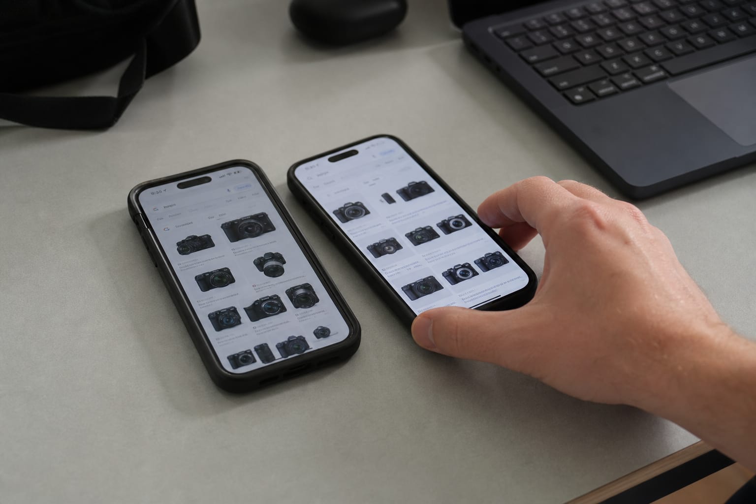 Two phones on a desk showing the same search returning different result orders