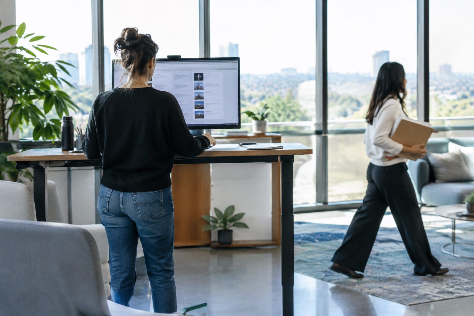 Business owner at a cafe counter viewing a laptop with a step-by-step SEO workflow diagram and a rising traffic chart