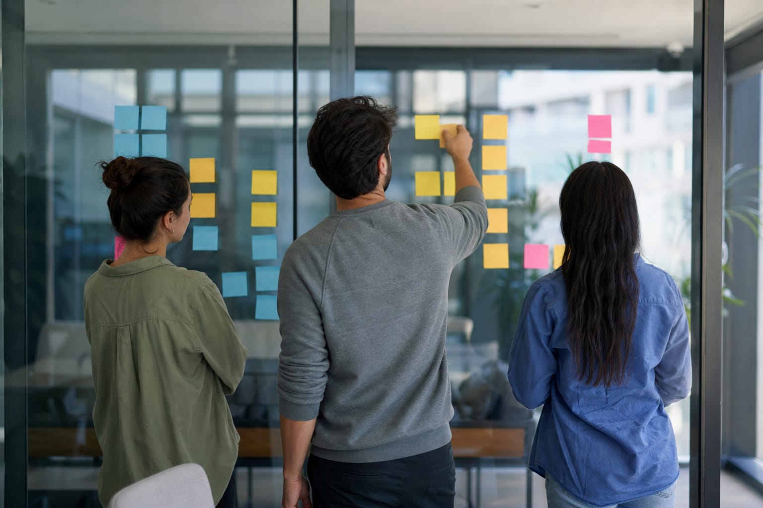 Three marketers moving sticky notes across a workflow board labeled Research, Draft, Review, Publish.
