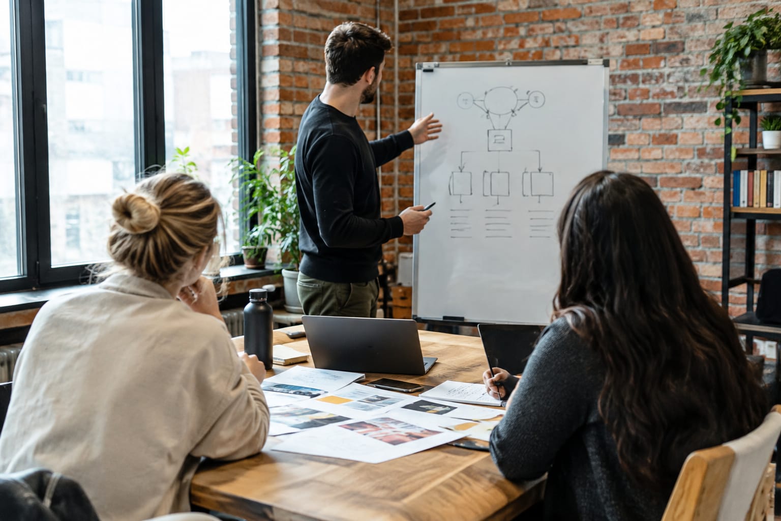 Agency owner at a desk with one monitor showing a rising traffic chart and another listing client websites
